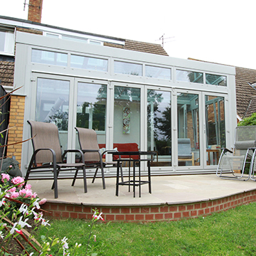 Glass front conservatory with bifold doors