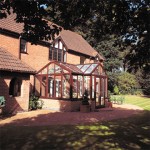 T-shaped conservatory with timber-effect frames