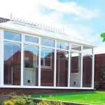 White uPVC Victorian Conservatory in a sunny garden